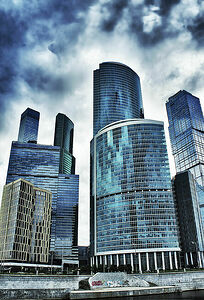 The city, clad in glass and concrete under a heavy rainy sky, looks like lead armor. Cramped.